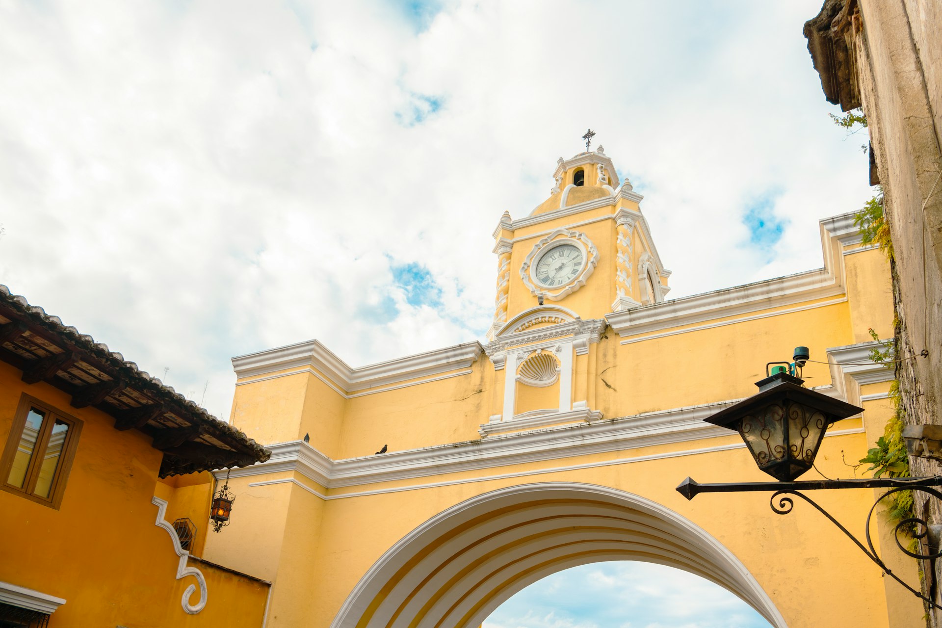 A yellow building with a clock tower in the background